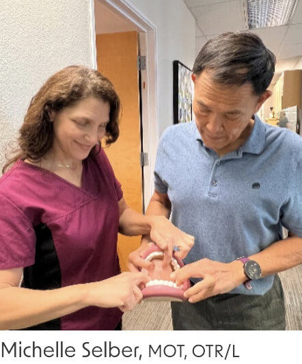 Dr. Ligh showing teeth to an assistant