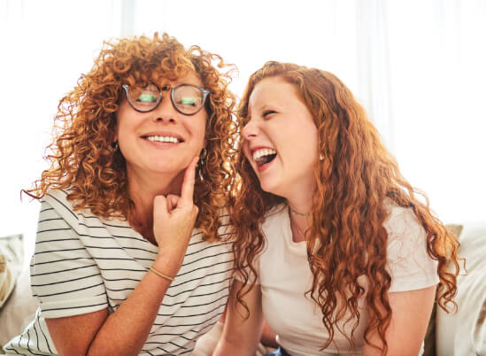 Mother and daughter laughing on a couch kids dentist in San Jose, CA